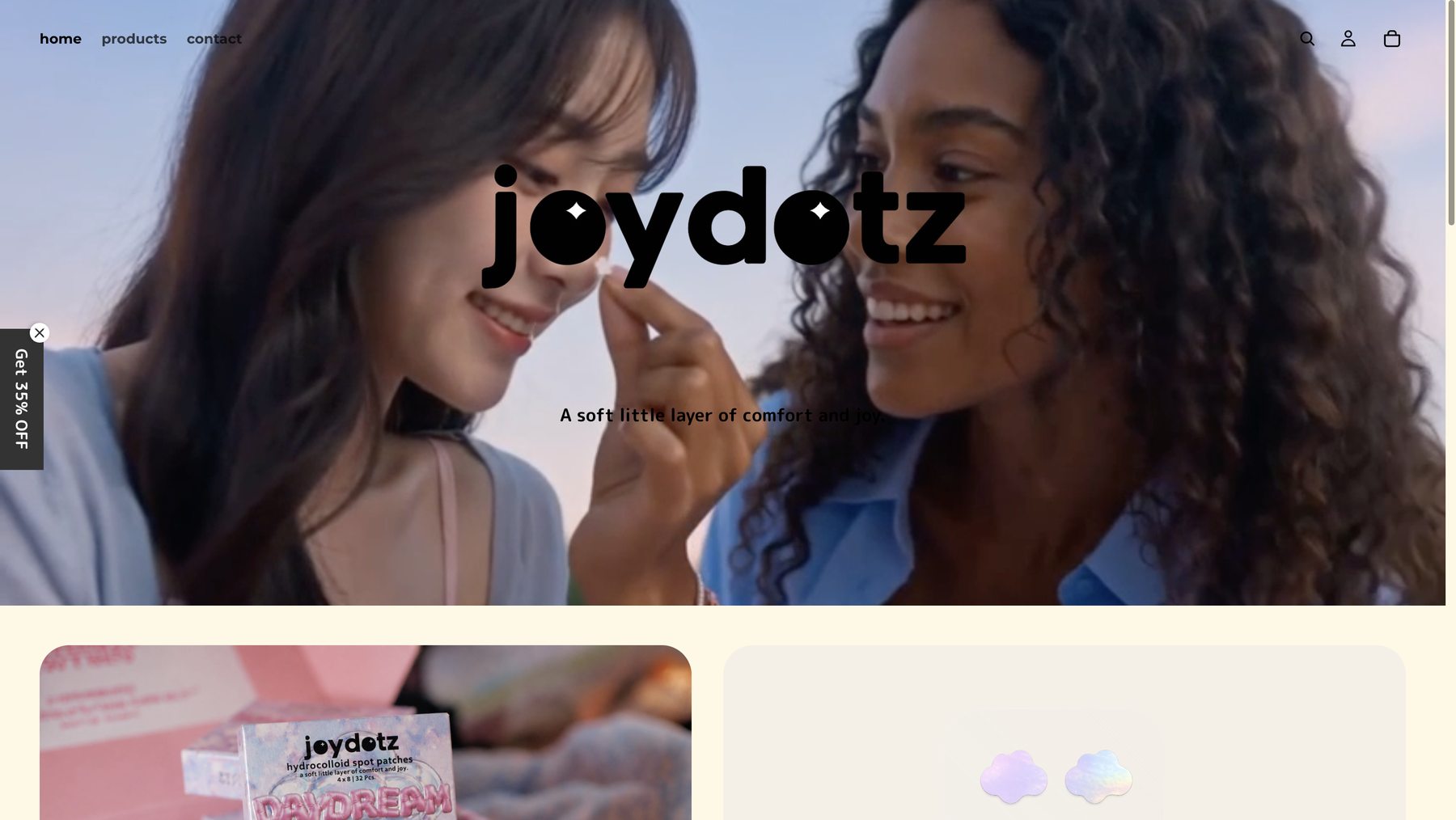 Joydotz homepage after — video hero with big sparkle logo